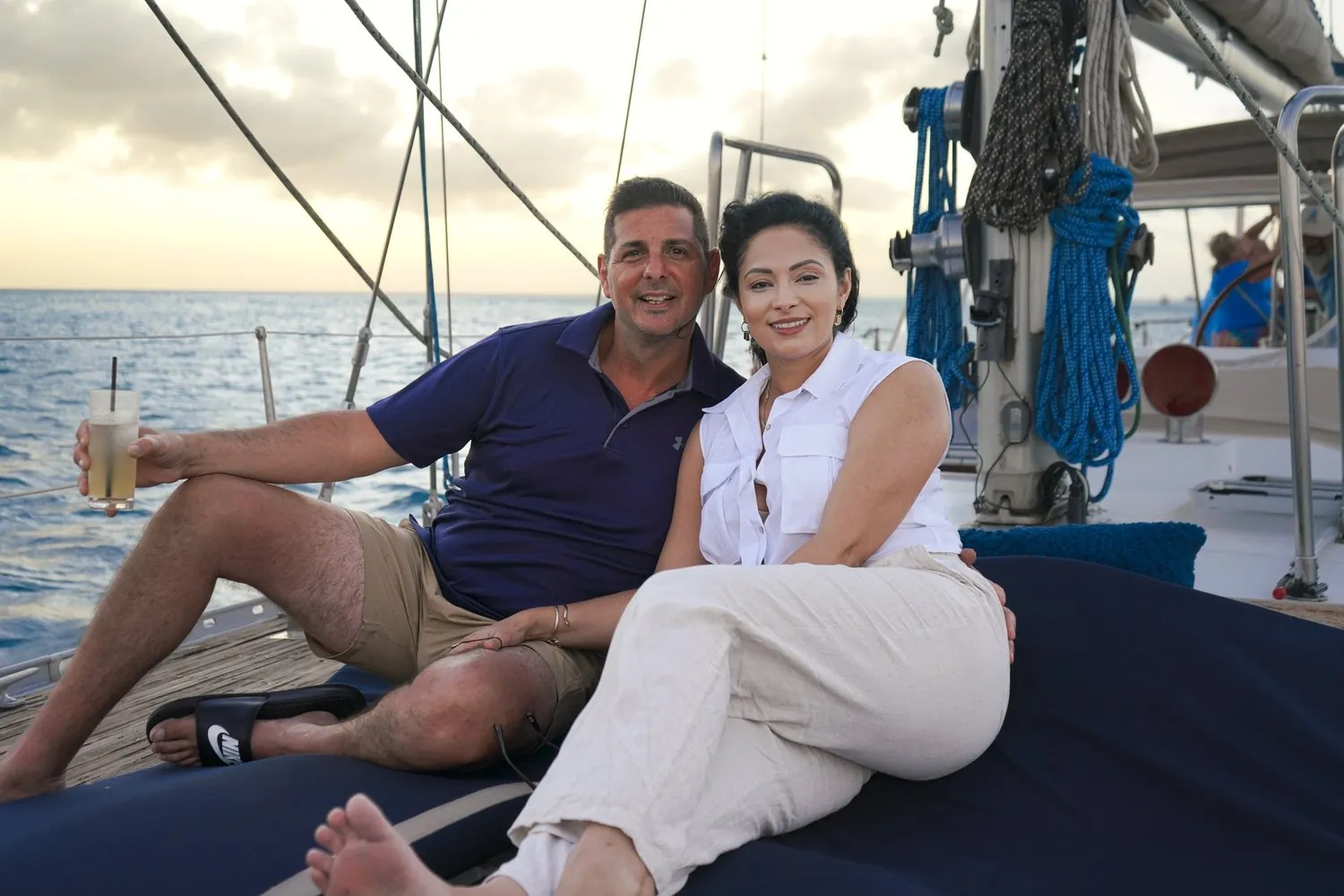 Couple relaxing on the deck of a sailboat at sea in Aruba