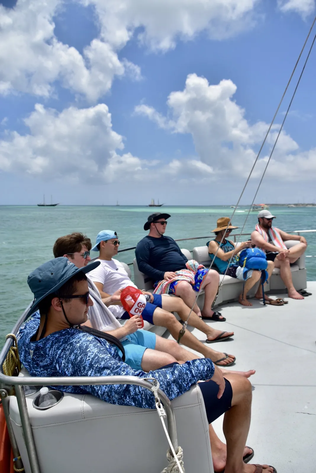 Guests relaxing on the deck of a boat at sea in Aruba