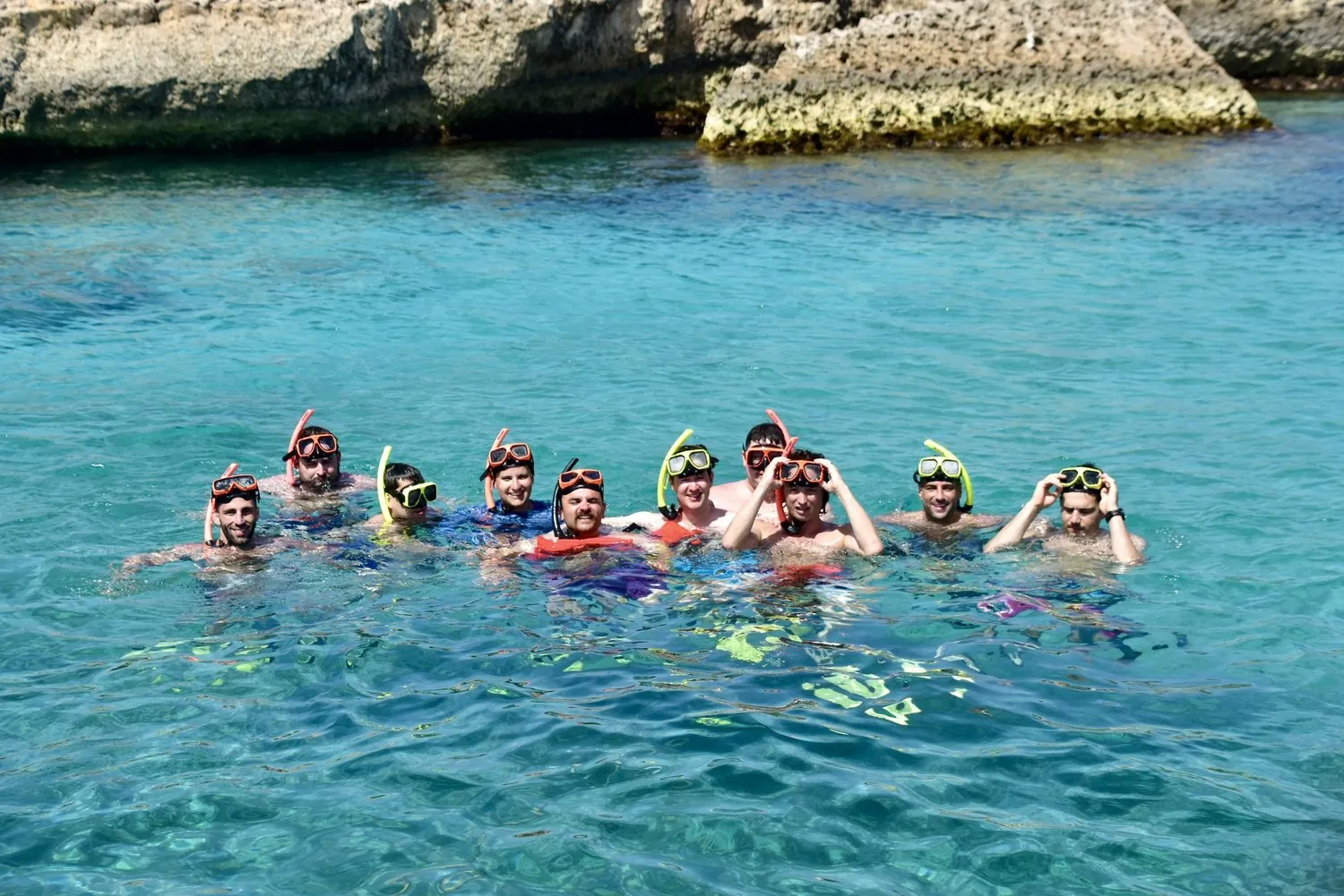 Group of friends snorkeling in clear turquoise water in Aruba