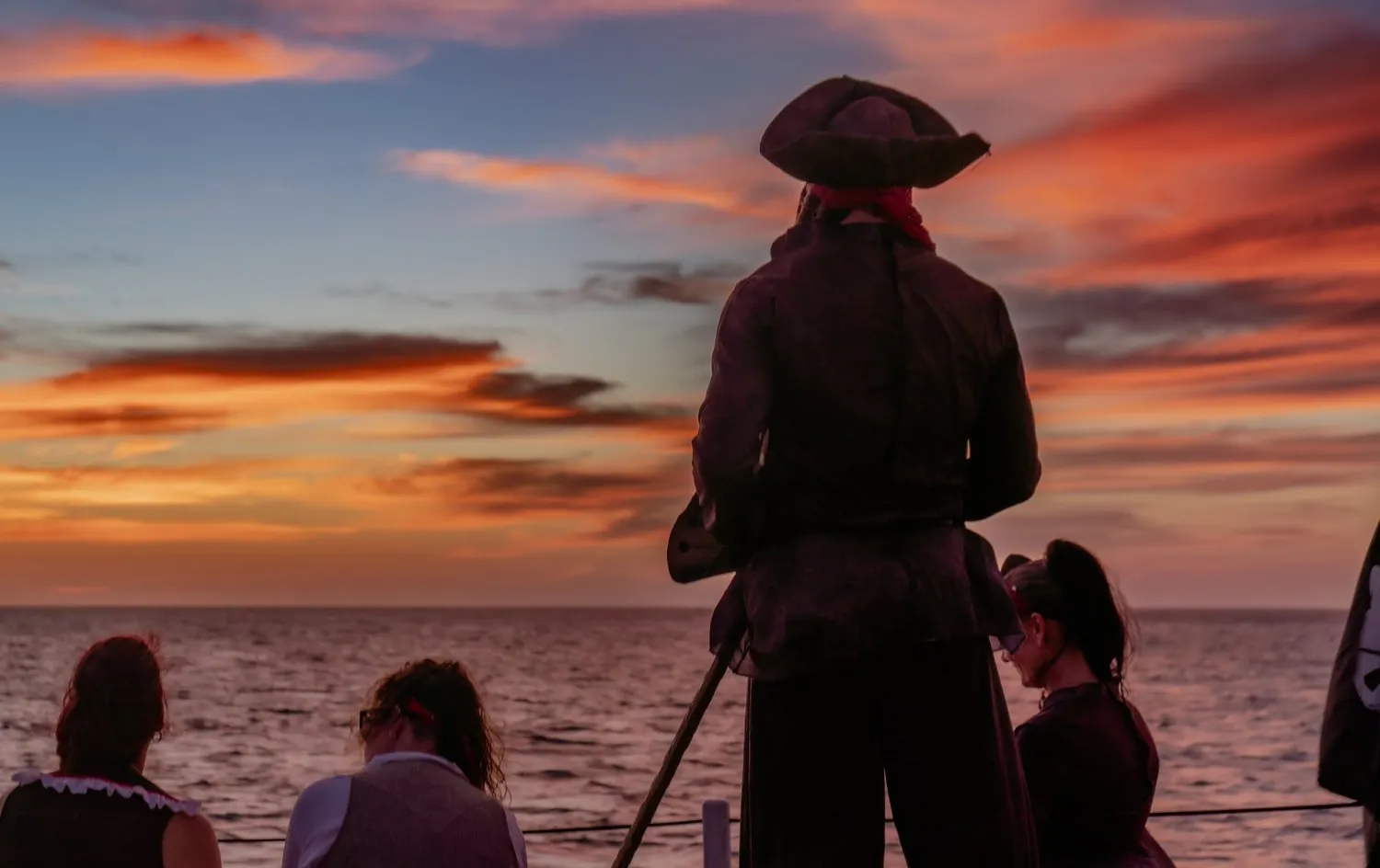 Pirate at the bow of a boat at sunset in Aruba