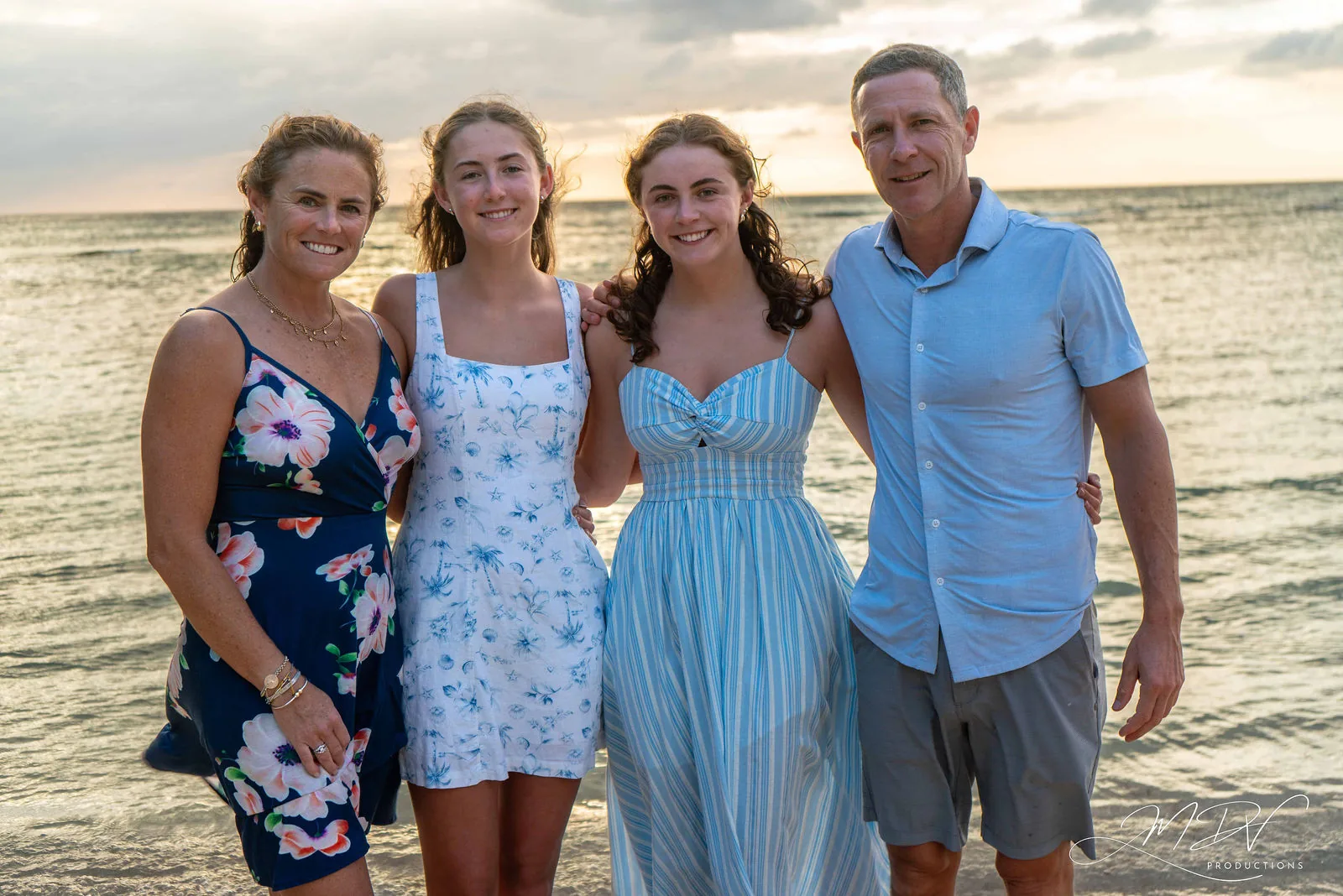 Parents with their two teenage daughters by the sea in Aruba