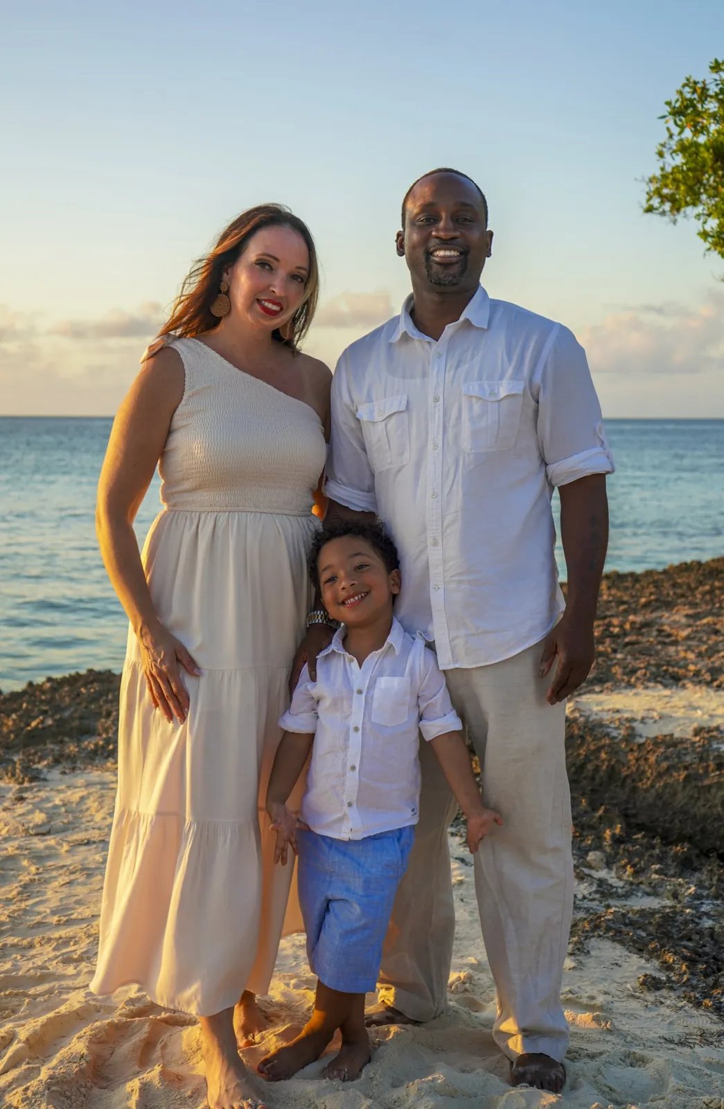 Parents with their young son on the beach at sunset in Aruba