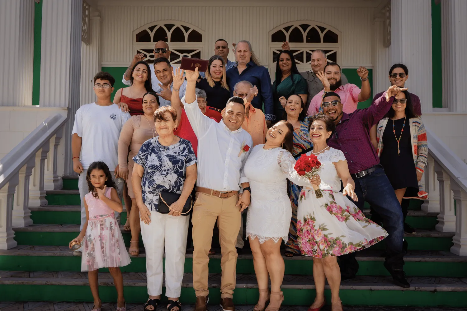 Wedding couple and guests on the steps of the venue in Aruba